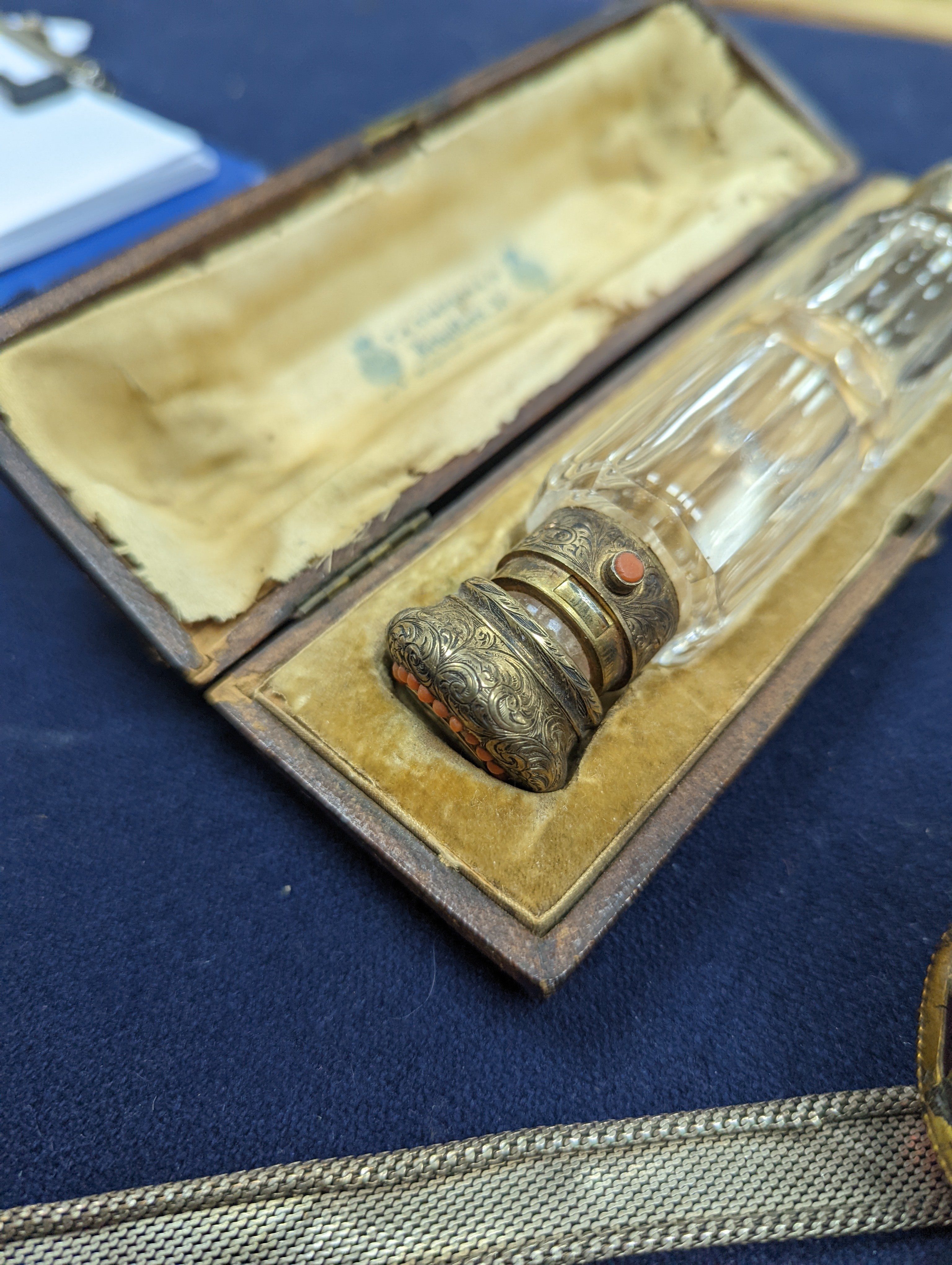 A cased Victorian engraved gilt white metal and coral set double ended scent bottle, 13.4cm, a silver cigar cutter, a belt, a silver buckle, gilt and cranberry perfume bottle, etc.